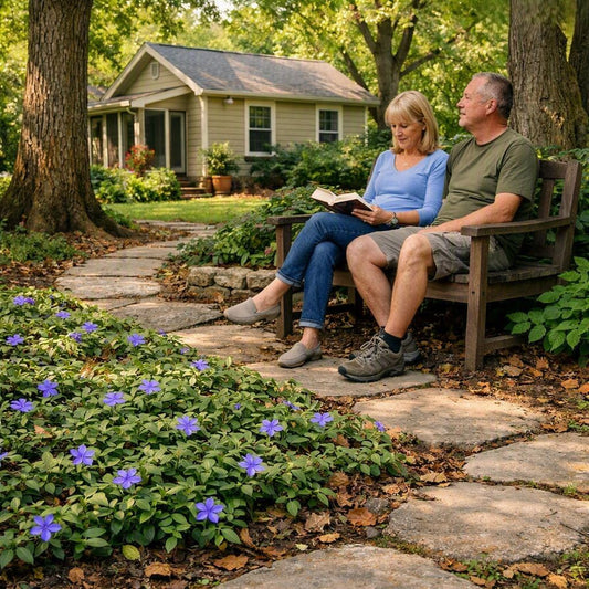 A peaceful garden scene with two people sitting on a wooden bench, one reading a book, surrounded by purple flowers, trees, and a small house in the background.
